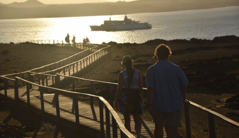 Bartolome in Galapagos Islands, landscape with a road, tourist and a view of the Galapagos Legend in the sea