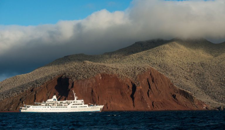 Rabida in Galapagos Islands, view of the red sand with Galapagos Legend