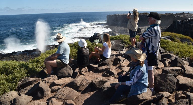 Suarez Point - Española in Galapagos Island Landscape view of the blowhole and tourist looking the sea