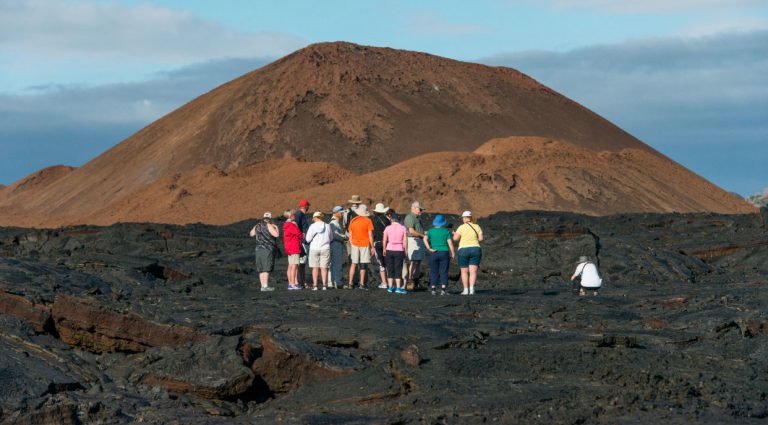 Sullivan bay, solid volcanic lava with tourist watching all